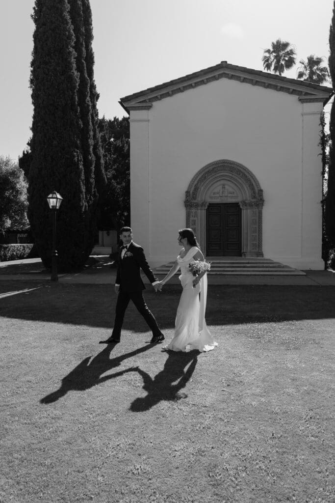 Bride and groom walking together outside.