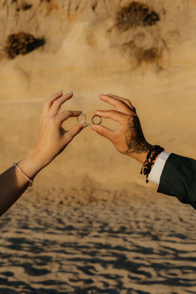 Bride and groom holding their rings together. 